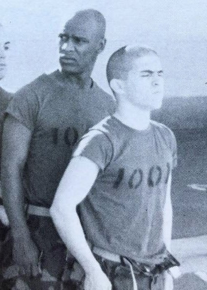 Eric Sanchez as a recruit in Platoon 1001 training gear during Marine Corps boot camp, a drill instructor behind him
